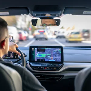 A driver is driving a car, and the behavior monitoring system is running.