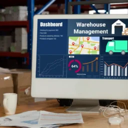 a computer monitor on a table with warehouse management software