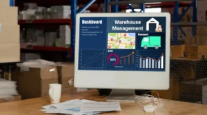 a computer monitor on a table with warehouse management software