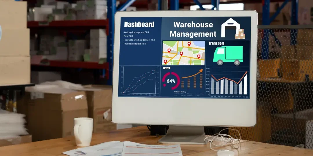 a computer monitor on a table with warehouse management software