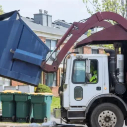 a truck loading a garbage container for waste management company