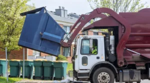 a truck loading a garbage container for waste management company