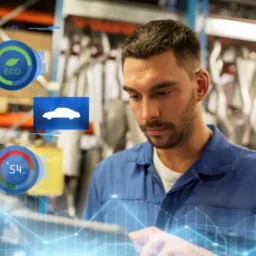 mechanic man with a tablet using automotive fleet maintenance software at a workshop